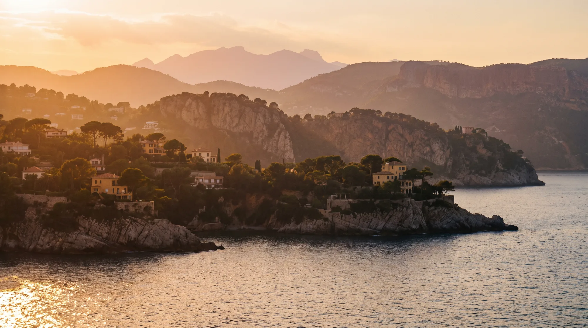 The Riviera coastline from the water at golden hour.